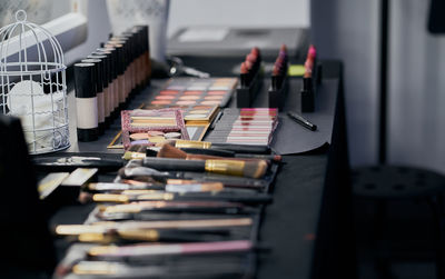 Make up palettes and brushes on a dressing table