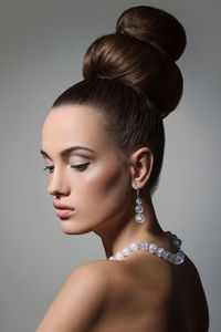 Close-up of beautiful fashion model against gray background