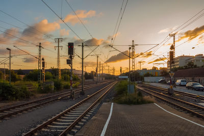 Railroad tracks against sky during sunset
