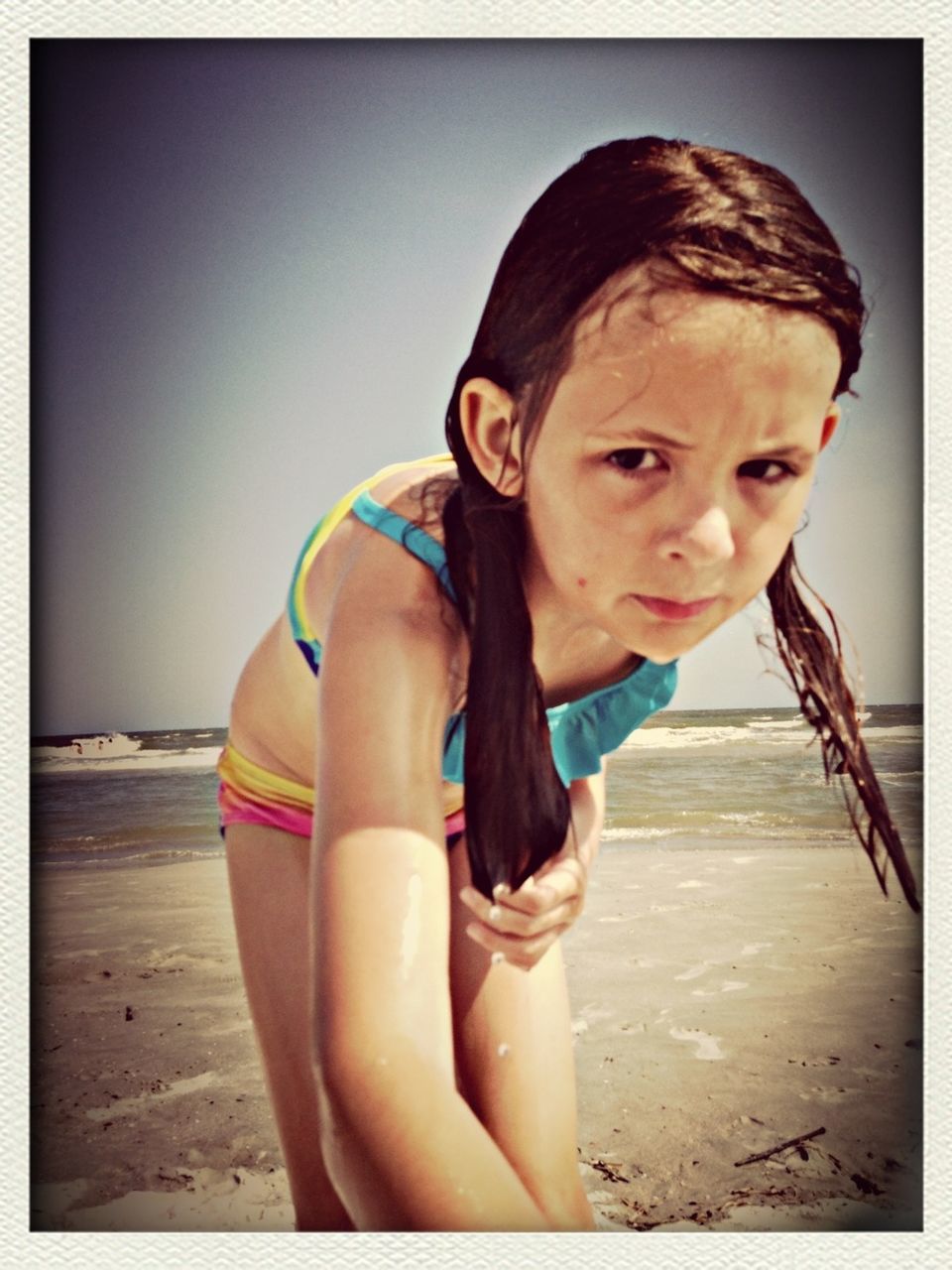 transfer print, beach, person, young adult, lifestyles, auto post production filter, leisure activity, sea, sand, young women, sitting, relaxation, shore, looking at camera, water, portrait, casual clothing, front view