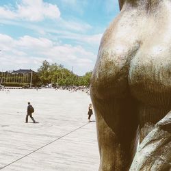 Men in sunlight against sky