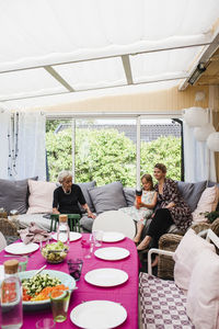 Family sitting in conservatory