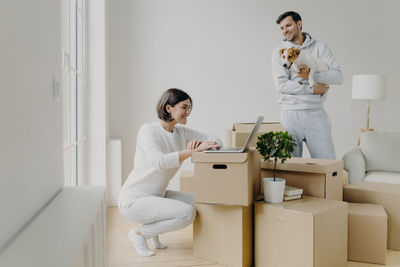 Man looking at woman using laptop