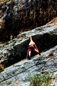 Full length of woman standing on rock
