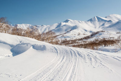 Snowcapped mountains against clear blue sky