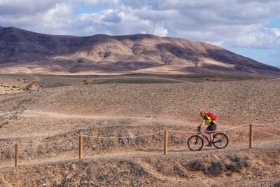 Man riding bicycle on mountain road