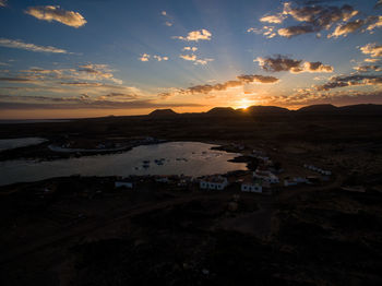 Scenic view of land against sky during sunset