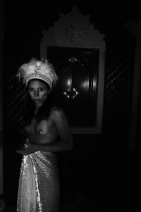 Portrait of young woman standing at night