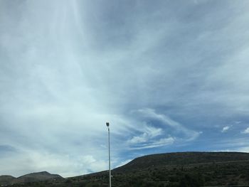 Scenic view of mountains against cloudy sky