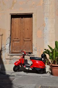 Motorcycle against red door