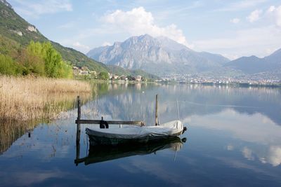 Scenic view of lake and mountains against sky