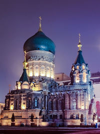 Illuminated cathedral against sky at night