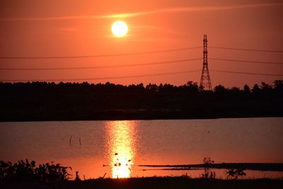 Scenic view of lake against orange sky