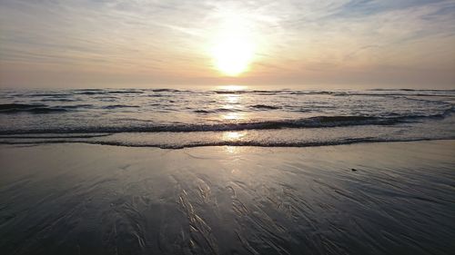 Scenic view of beach against sky during sunset