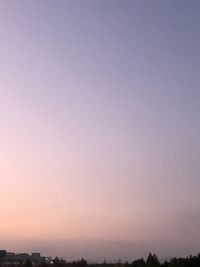 Silhouette landscape against clear sky at sunset