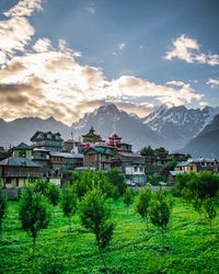 Scenic view of buildings and mountains against sky