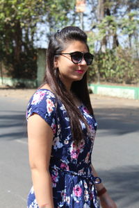 Young woman wearing sunglasses standing outdoors