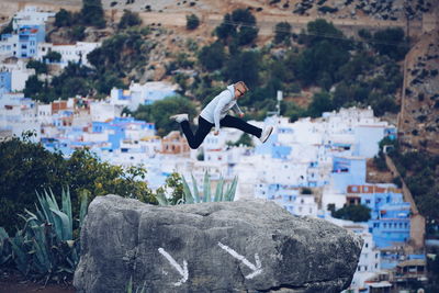 Man jumping over town