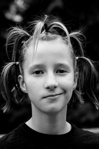 Close-up of cute teenage girl with crazy hairstyle smiling sarcastically 