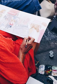 High angle view of man sitting on table