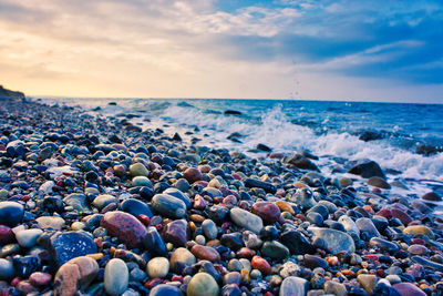 View of pebbles on beach against sky