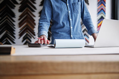 Low section of person working on table