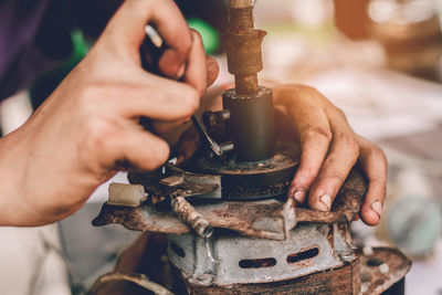 Midsection of man working at machine