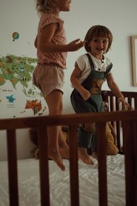 High angle view of siblings playing with toys