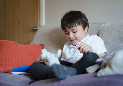 Portrait of boy playing with daughter at home