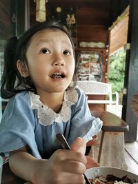 Portrait of cute girl holding a restaurant