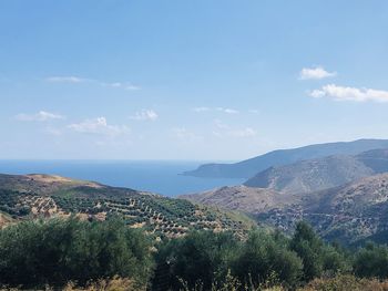 Scenic view of sea and mountains against sky