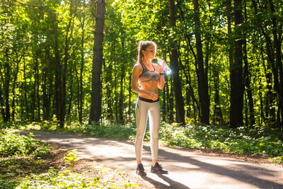 Full length of young woman in forest