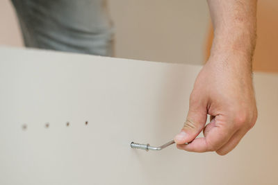 Close-up of man working on white table