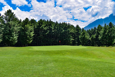 Scenic view of golf course against sky