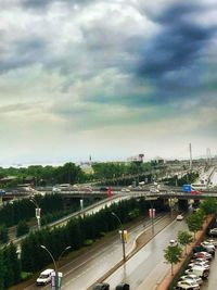 High angle view of vehicles on highway in city against sky