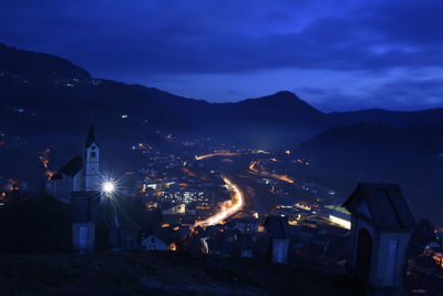 Illuminated cityscape against sky at night