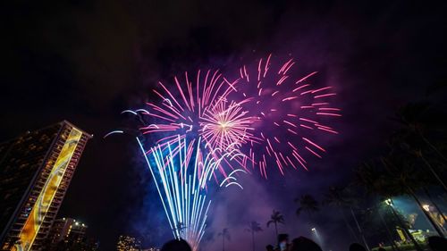 Low angle view of firework display at night