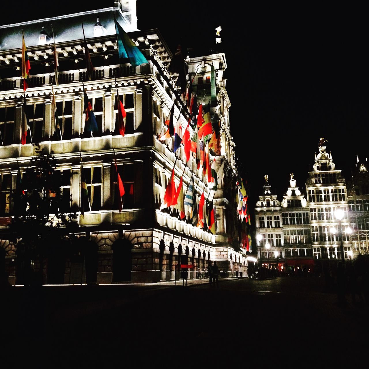 building exterior, night, illuminated, architecture, built structure, city, lighting equipment, street light, low angle view, building, clear sky, outdoors, sky, no people, light - natural phenomenon, travel destinations, city life, exterior, facade, street