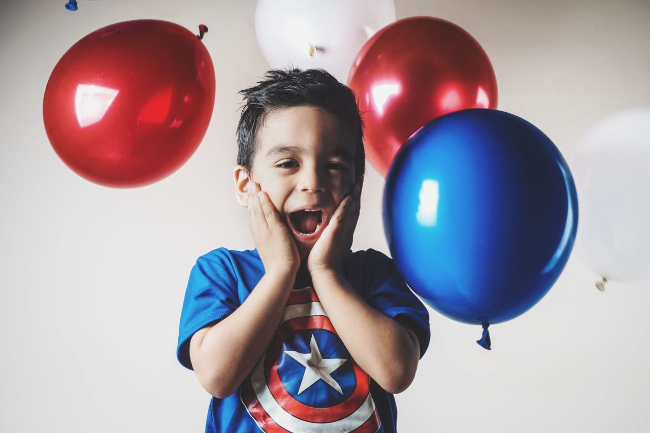 balloon, child, childhood, one person, red, boys, front view, leisure activity, real people, indoors, standing, males, looking at camera, portrait, holding, lifestyles, celebration, helium balloon, innocence