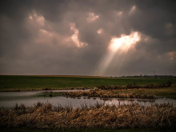 Scenic view of field against sky during sunset