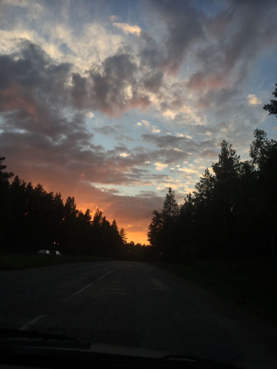 ROAD BY TREES AGAINST SKY SEEN THROUGH CAR WINDSHIELD