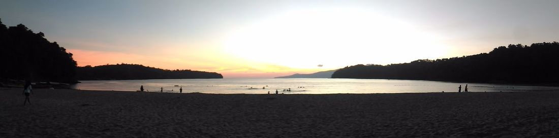 Scenic view of beach against sky during sunset