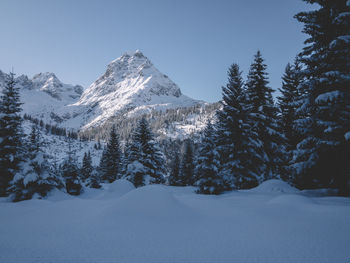 Scenic view of snowcapped mountains against clear sky