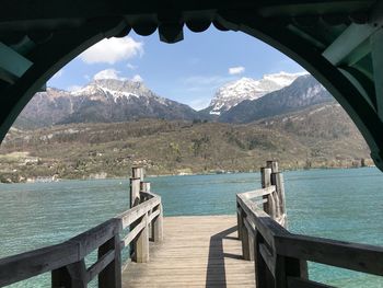 Scenic view of sea and mountains against sky