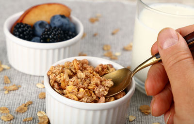 Cropped hand having food on table