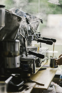 Barista making coffee in cafe