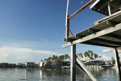 Low angle view of bridge over river against sky