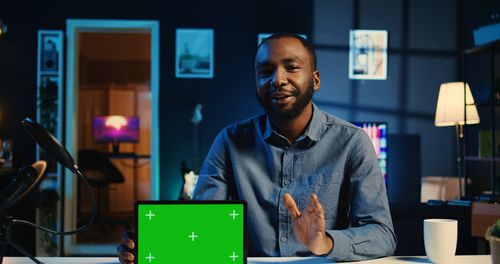 Portrait of young man using digital tablet at office