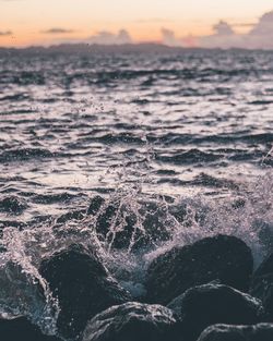 Close-up of sea against sky during sunset