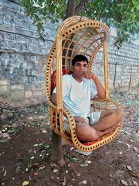 Portrait of smiling young man sitting outdoors